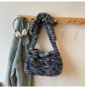 Detail of grey faux fur tote bag showing plush texture and integrated wide strap