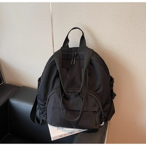Detail of black nylon tote backpack with adjustable straps and drawstring side pocket