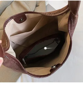 Detailed view of large capacity tote bag interior with multiple pockets and magnetic buckle