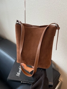 Retro brown frosted bucket bag with FASHION & BAGS text and leather shoulder strap