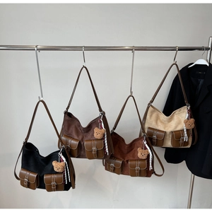 Detail view of retro tote bags in four colors with leather pockets and bear charms