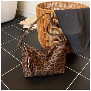 Detail of vintage leopard print tote with beaded tassel zipper and adjustable strap