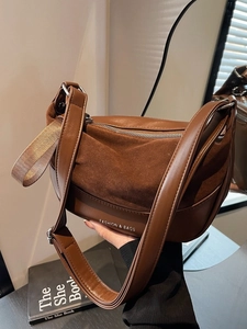 Vintage brown leather saddle bag with wide shoulder strap and suede stitching details