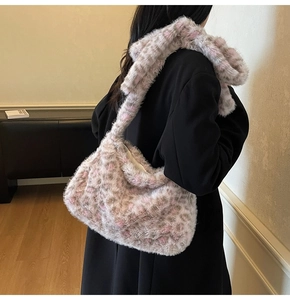 Detail showing the plush texture and animal print of the shoulder bag worn by model