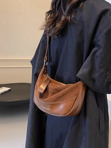 Vintage brown frosted matte saddle bag with stylish wide shoulder strap shown on model