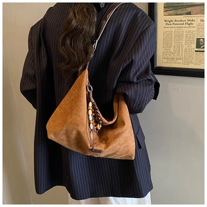 Brown suede hobo bag featuring ethnic wooden bead tassels and premium leather shoulder strap