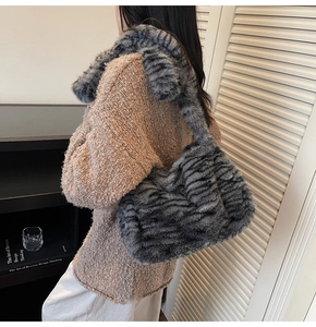 Detail view of stylish leopard print faux fur tote bag styled with winter knitwear