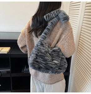 Detail view of tiger stripe faux fur tote bag with plush shoulder strap for winter
