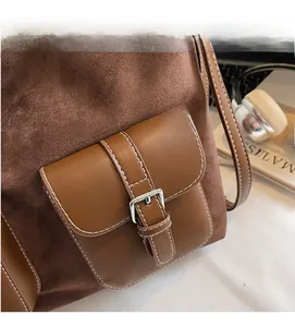 Detail of vintage brown tote bag featuring suede stitching and white contrast stitching