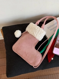 Pink suede Christmas stocking crossbody bag with white faux fur trim and adjustable strap