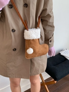 Creative boot-shaped crossbody bag in brown suede with white faux fur trim and leather strap