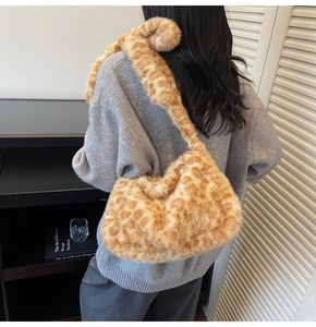 Close-up of leopard print plush tote bag showing soft faux fur texture and shoulder strap