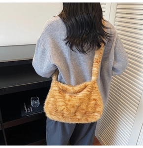 Detail of tiger pattern plush tote bag showing soft faux fur texture and slouchy drape