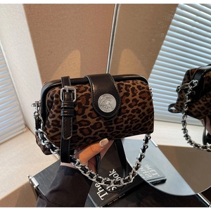 Detail of leopard print pillow bag featuring silver chain and vintage embossed buckle