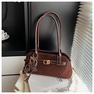 Detail view of dark brown frosted suede shoulder bag with gold buckle and Love charm