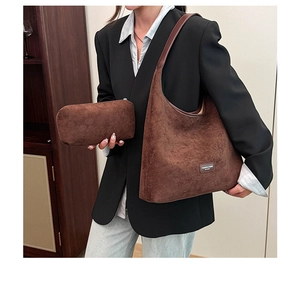 Detail of dark brown suede hobo bag set with shoulder strap and matching pouch