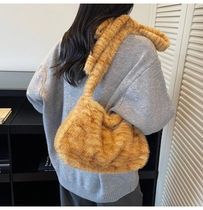 Detail of soft plush tote bag featuring orange cat pattern texture and wide strap