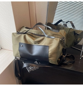 Detail of olive green travel bag with black PU handles and durable metal zippers