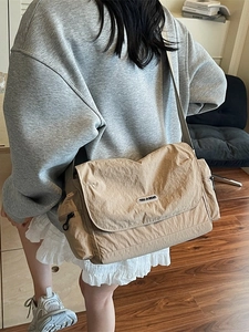 Minimalist khaki messenger tote bag with nylon texture and casual crossbody design