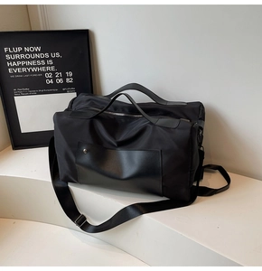 Detail of waterproof nylon travel bag with leather accents and durable metal buckles