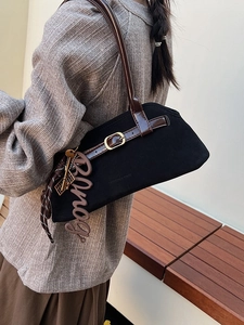 Vintage black matte shoulder bag with brown leather straps and brass buckle detail