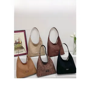 Detail showing five assorted colors and leopard print patterns of stylish hobo underarm bags