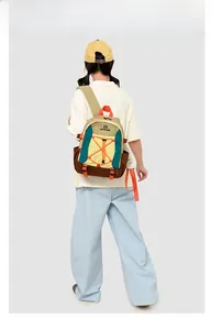 Outdoor color-block backpack detail featuring orange bungee cords and durable nylon fabric