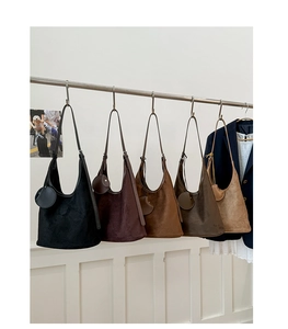 Variety of hobo bucket bags in matte suede leather shown in multiple autumn colors