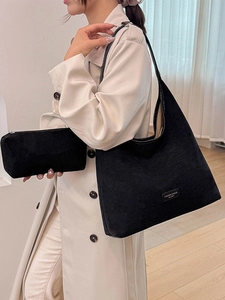 Chic black corduroy tote bag set with matching makeup pouch for a minimalist autumn look