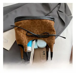 Detailed interior of leopard print tote bag showing storage for phone and cosmetics