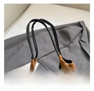 Detail of leopard print tote bag with black ribbon bow and thin handles in a lifestyle setting