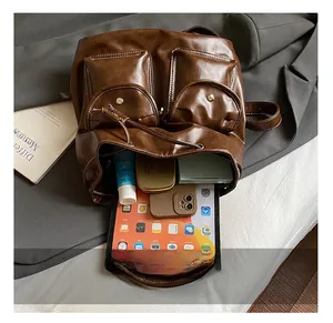 Internal view of brown vintage backpack showing capacity for tablet and cosmetics