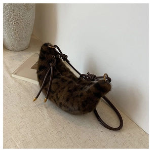 Détail d'un sac demi-lune en fausse fourrure léopard avec bandoulière à nœud marron