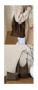 Detail view of brown suede tote bag set with matching inner pouch and smooth matte texture