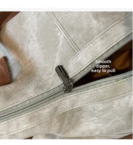 Detail of smooth metal zipper and durable canvas texture on a stylish tote bag