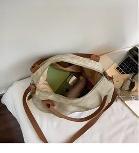 Detail view of large canvas tote bag showing interior capacity with umbrella and bottles