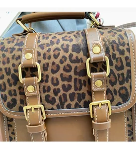 Detail of vintage leopard print handbag featuring premium gold hardware and stitching
