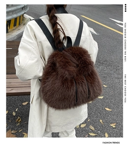 Detail of dark brown plush backpack with soft faux fur texture and drawstring closure