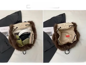 Macro view of spacious interior in a brown faux fur bucket bag showing daily essentials