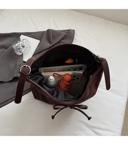 Interior view of brown suede tote bag showing large capacity for tablet and daily items