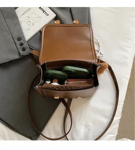 Internal view of brown faux leather backpack featuring leopard print lining and pockets