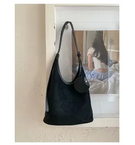 Detail of black faux suede tote bag with round coin purse and minimalist leather trim