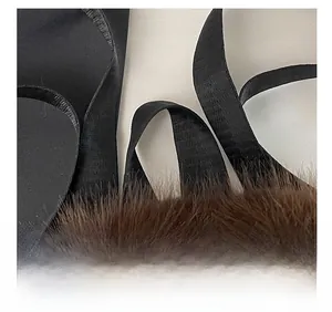 Detailed close-up of precise stitching and high-quality brown faux fur on the backpack