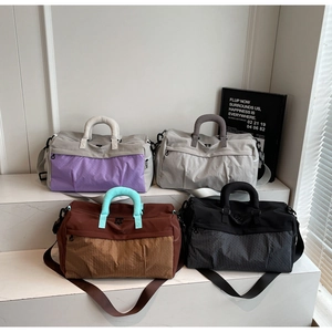 Four colors of large capacity travel bags with contrast stitching and shoulder straps