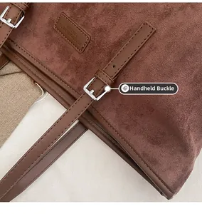 Close-up of adjustable silver pin buckle on brown suede tote bag leather strap