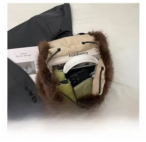 Top view of large capacity brown plush backpack showing storage for phone and wallet