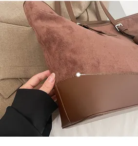 Close-up of stitching details on leopard tote bag with adjustable leather strap