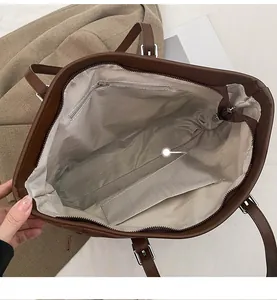 Detailed interior of leopard tote showing zipper pocket and herringbone lining