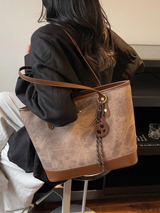 Minimalist large tote bag with vintage matte texture and brown leather straps on shoulder