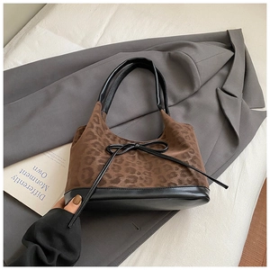 Detail of leopard print bucket bag with black leather straps and bow tie decoration